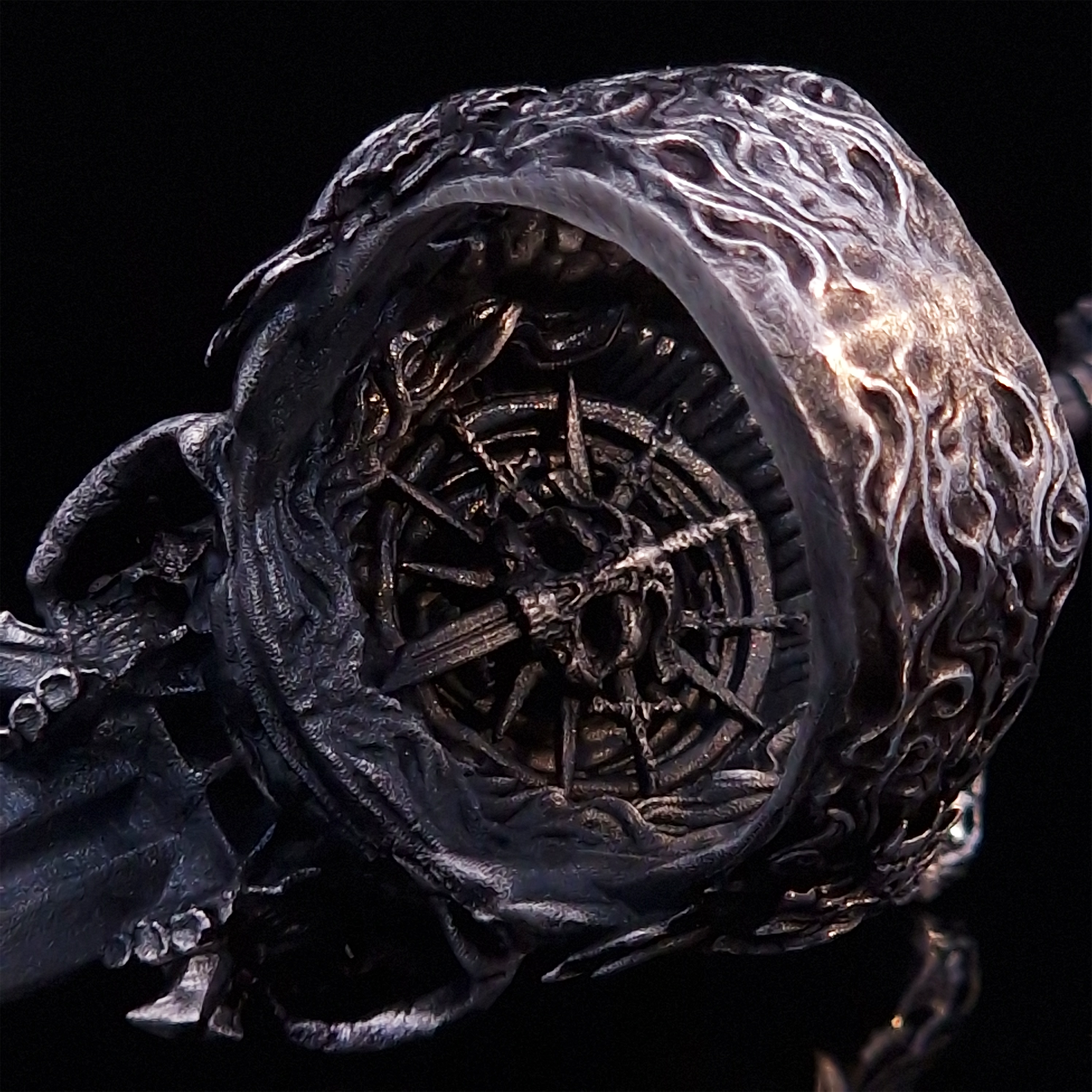 Close-up of the inner design of the Adversarius Mortis ring in the Fallen finish, against a black backdrop.