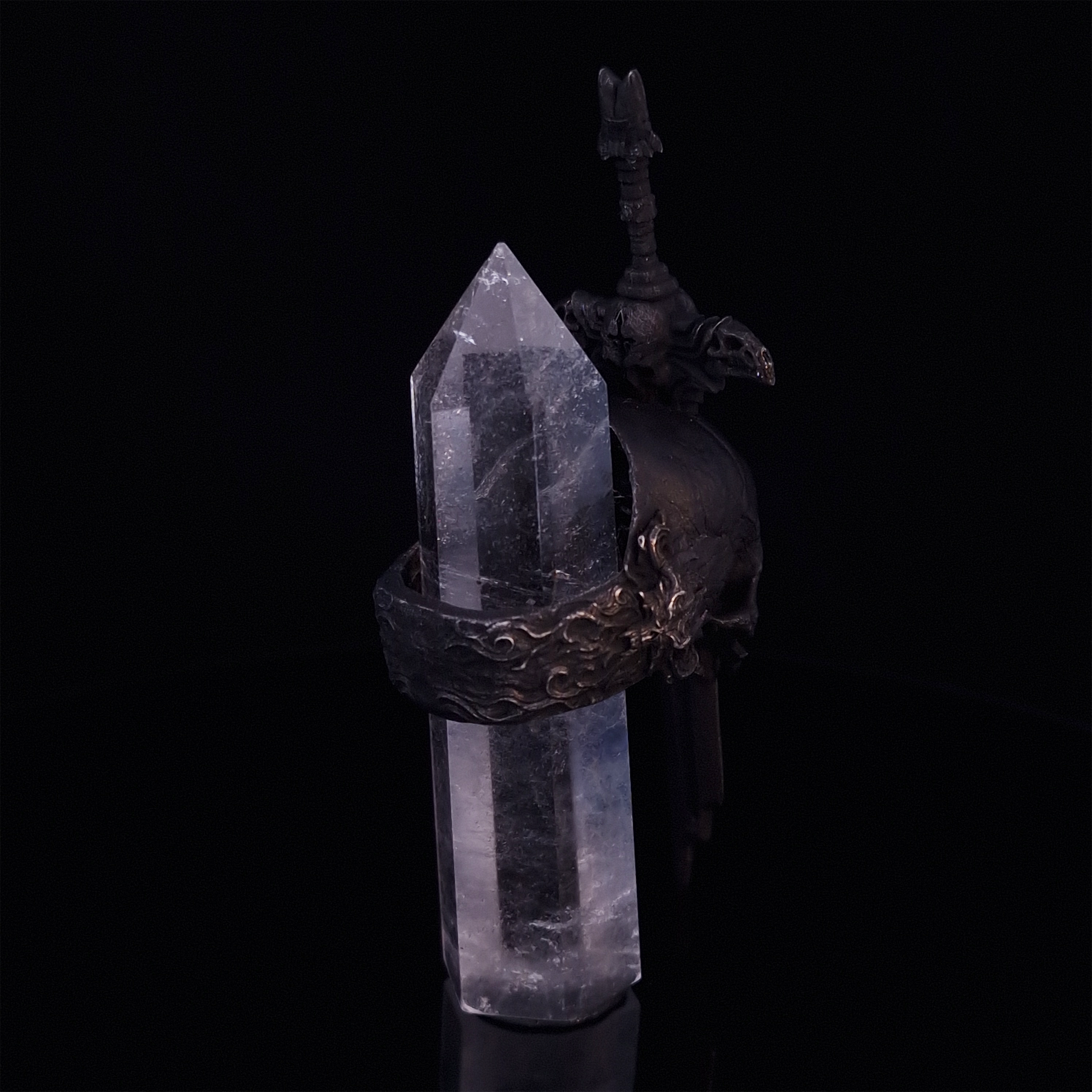 Rear-right view of the Adversarius Mortis ring in the Revenant 2 finish, with crystal support visible, focusing on the intricate band design.