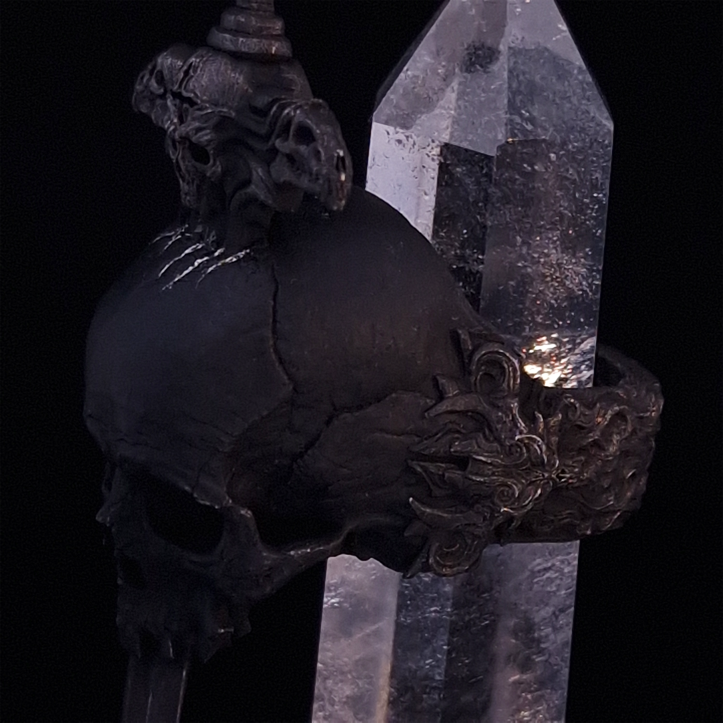 Close-up side-left view of the Adversarius Mortis ring in the Revenant 2 finish, with crystal support visible, highlighting the intricate band design on a turntable.