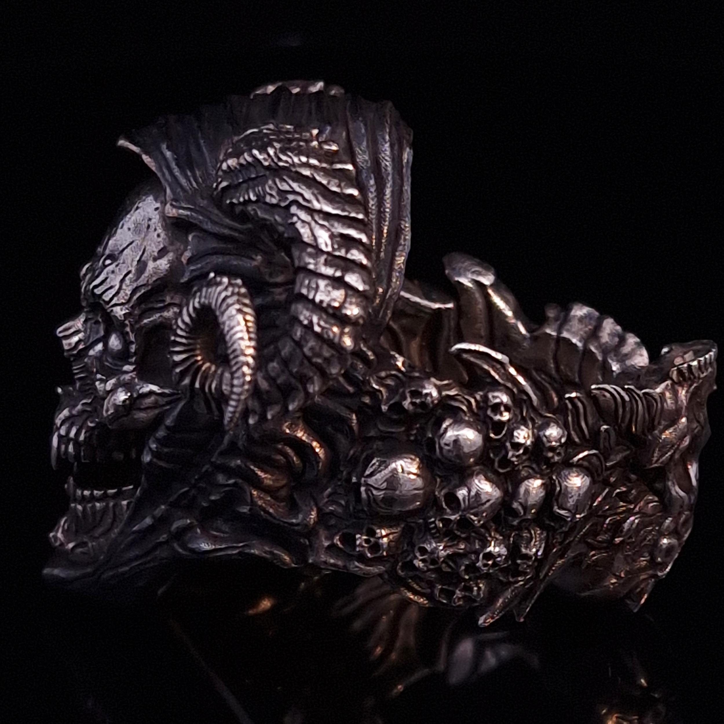 Left-facing side view highlighting the detailed band of the Sword of Damocles ring in the Fallen finish, shown on a turntable with a black background.
