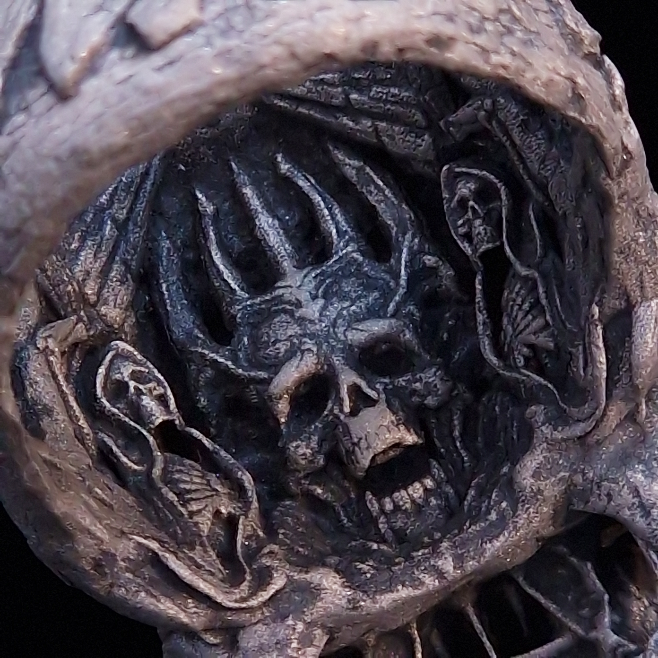 Close-up of the inner design of the Invidia Mortis ring in the Wraith finish, captured on a turntable with a black backdrop.
