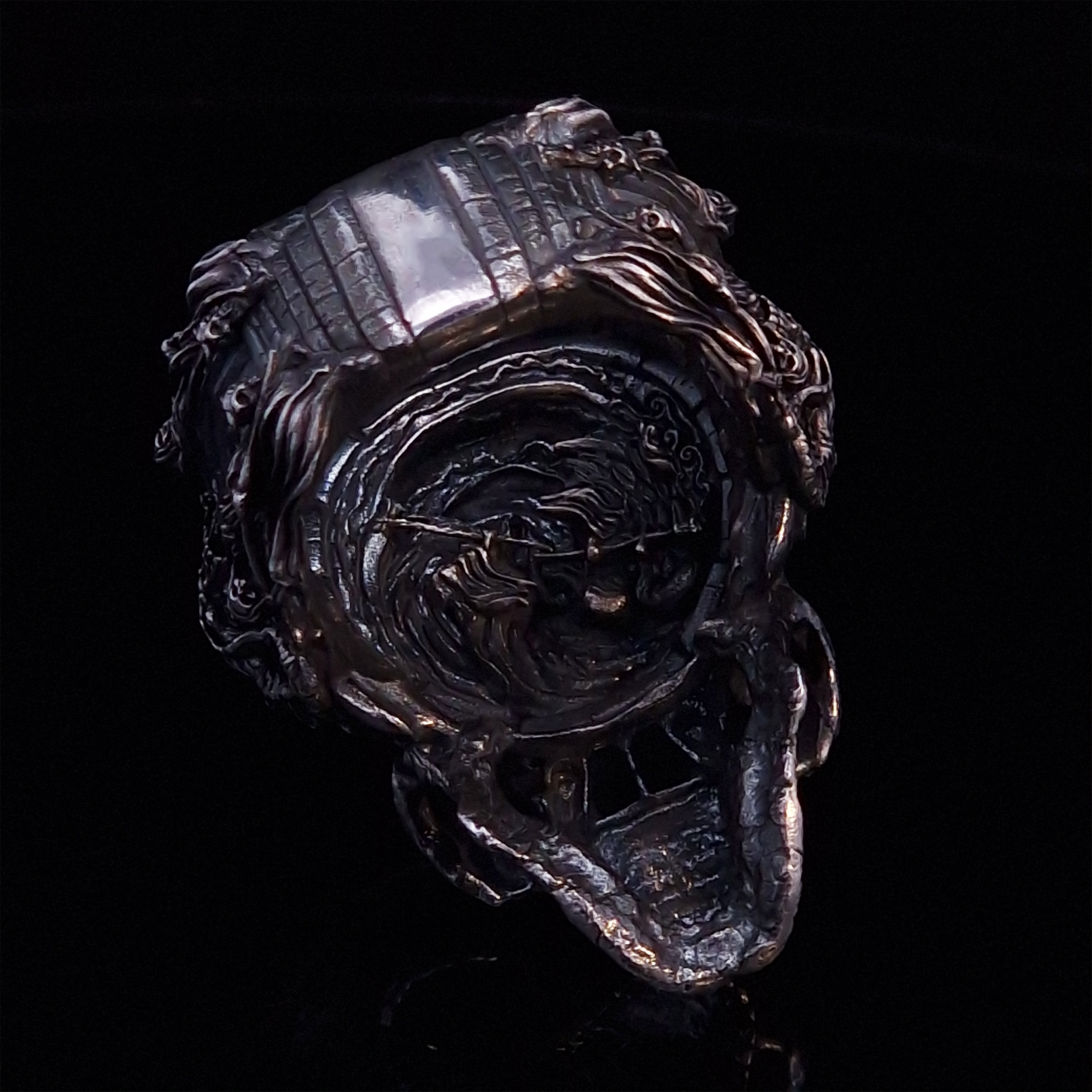 Back view of the Nexus Mortis ring in the Fallen finish, captured on a turntable with a black backdrop.