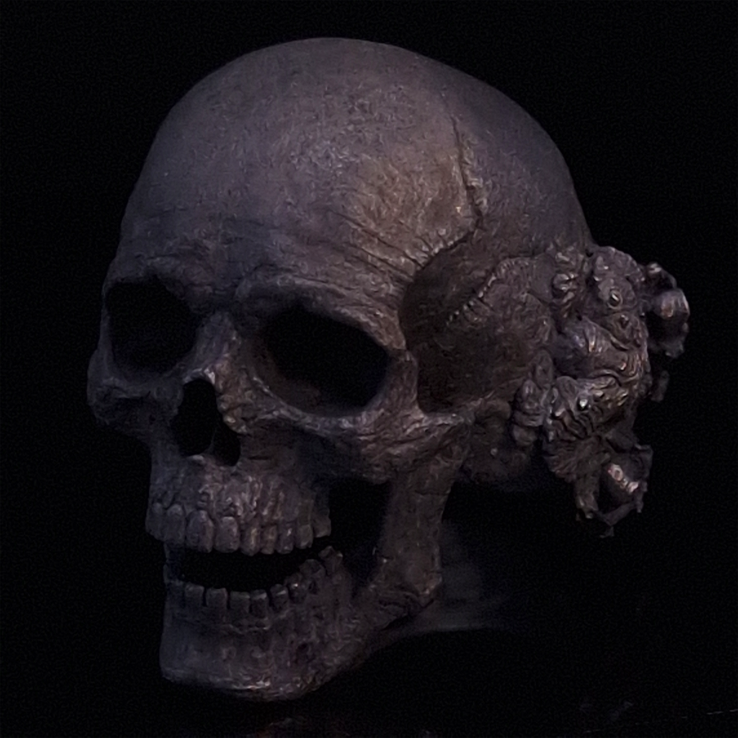 Front-left facing view of the Nexus Mortis ring in the Revenant 3 finish, displayed on a turntable against a black background.