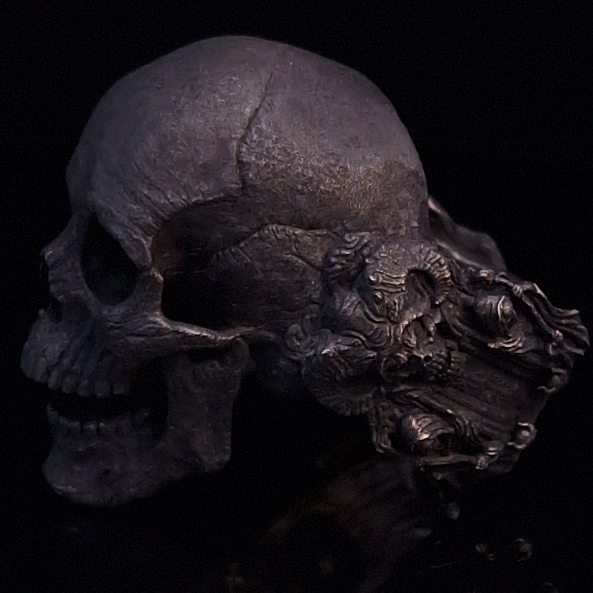 Side-left view highlighting the detailed band of the Nexus Mortis ring in the Revenant 3 finish, shown on a turntable with a black background.