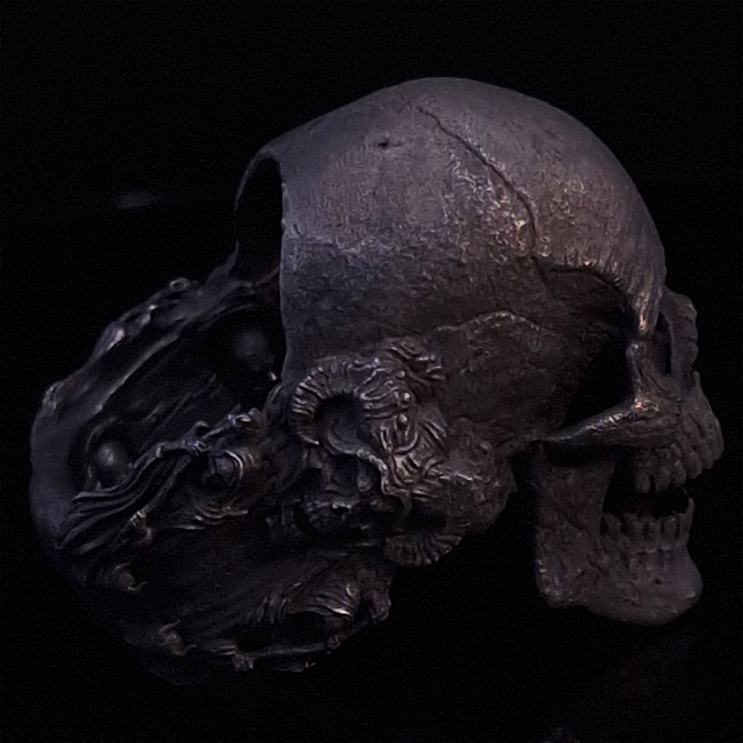 Side-right view highlighting the detailed band of the Nexus Mortis ring in the Revenant 3 finish, shown on a turntable with a black background.