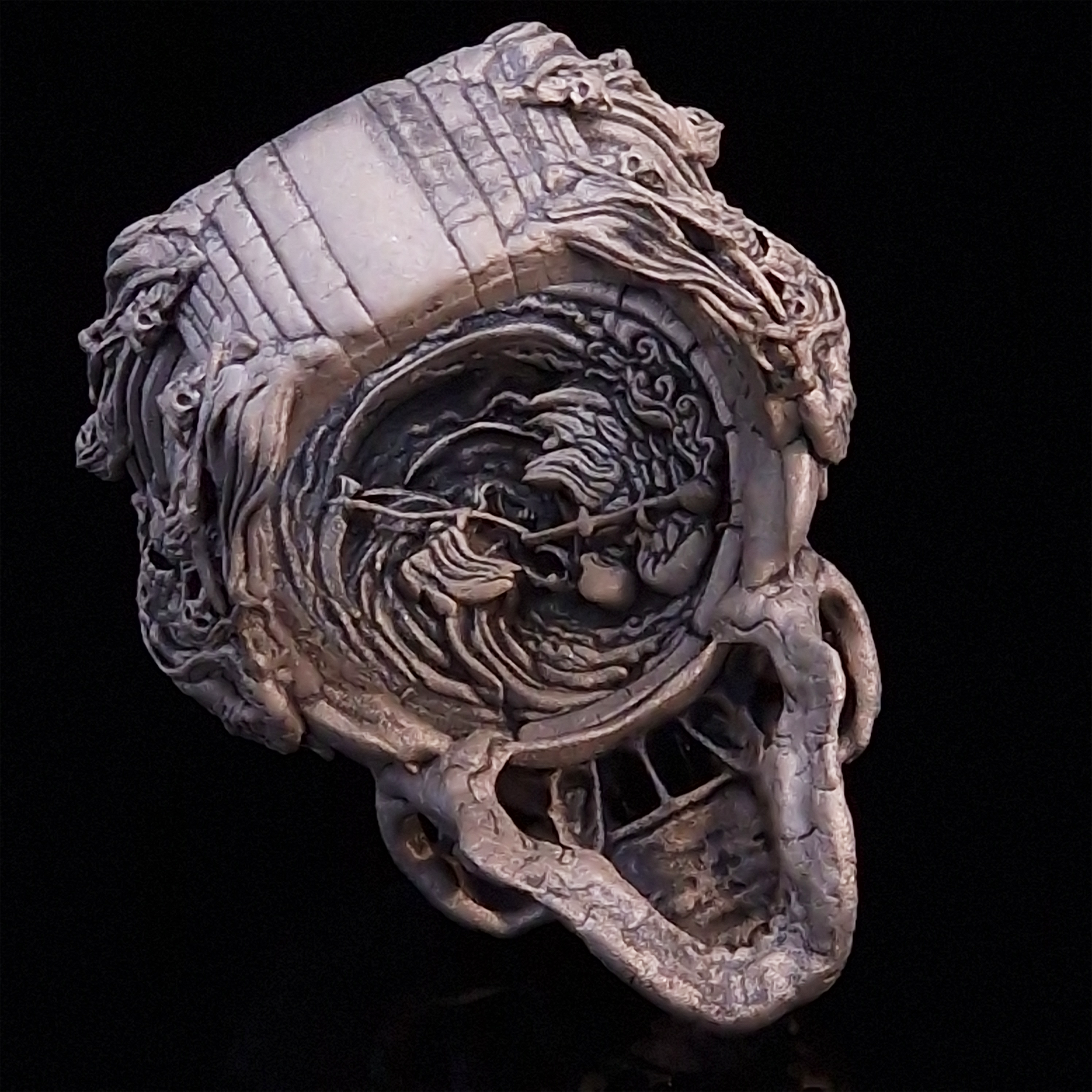 Back view of the Nexus Mortis ring in the Wraith finish, captured on a turntable with a black backdrop.