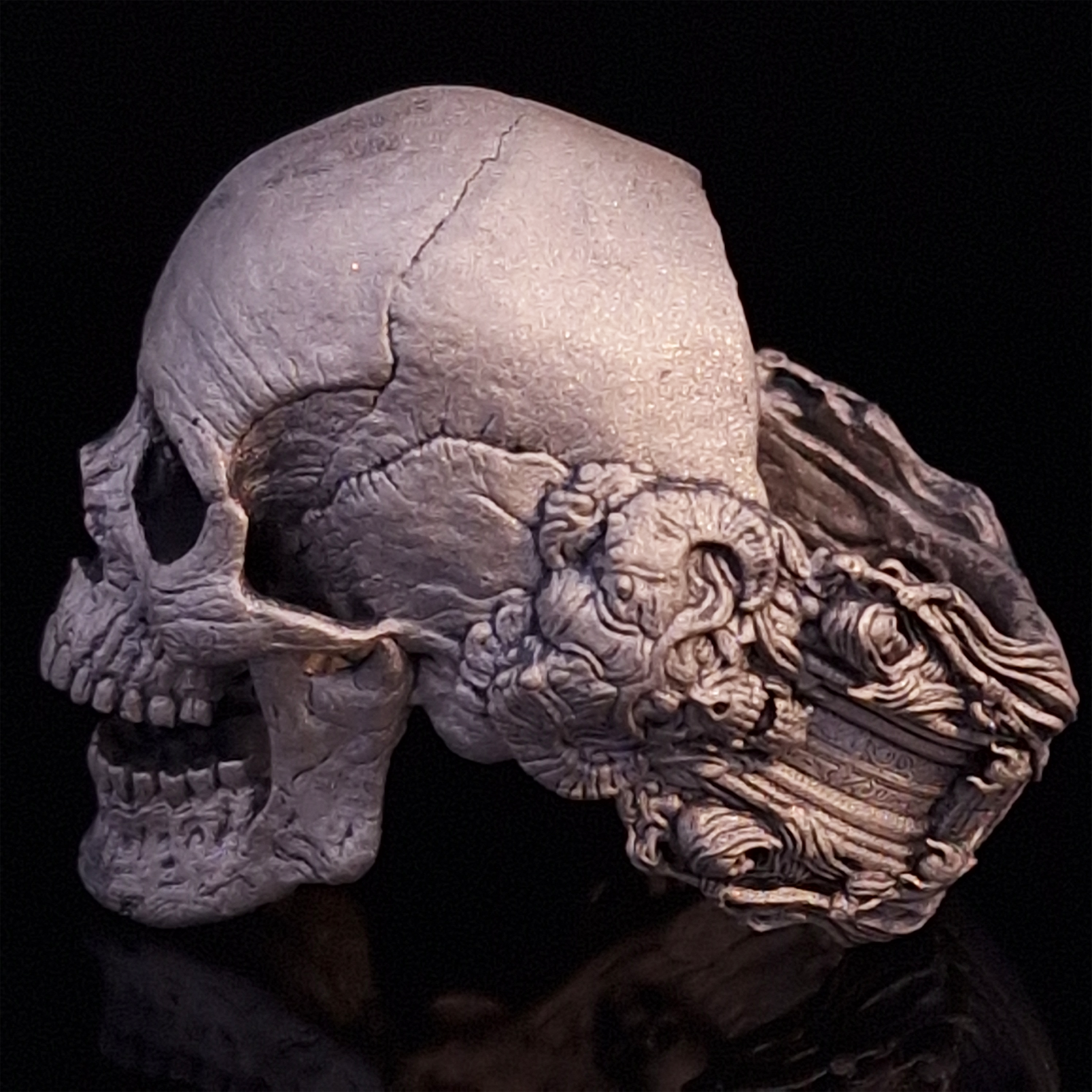 Side-left view highlighting the detailed band of the Nexus Mortis ring in the Wraith finish, shown on a turntable with a black background.