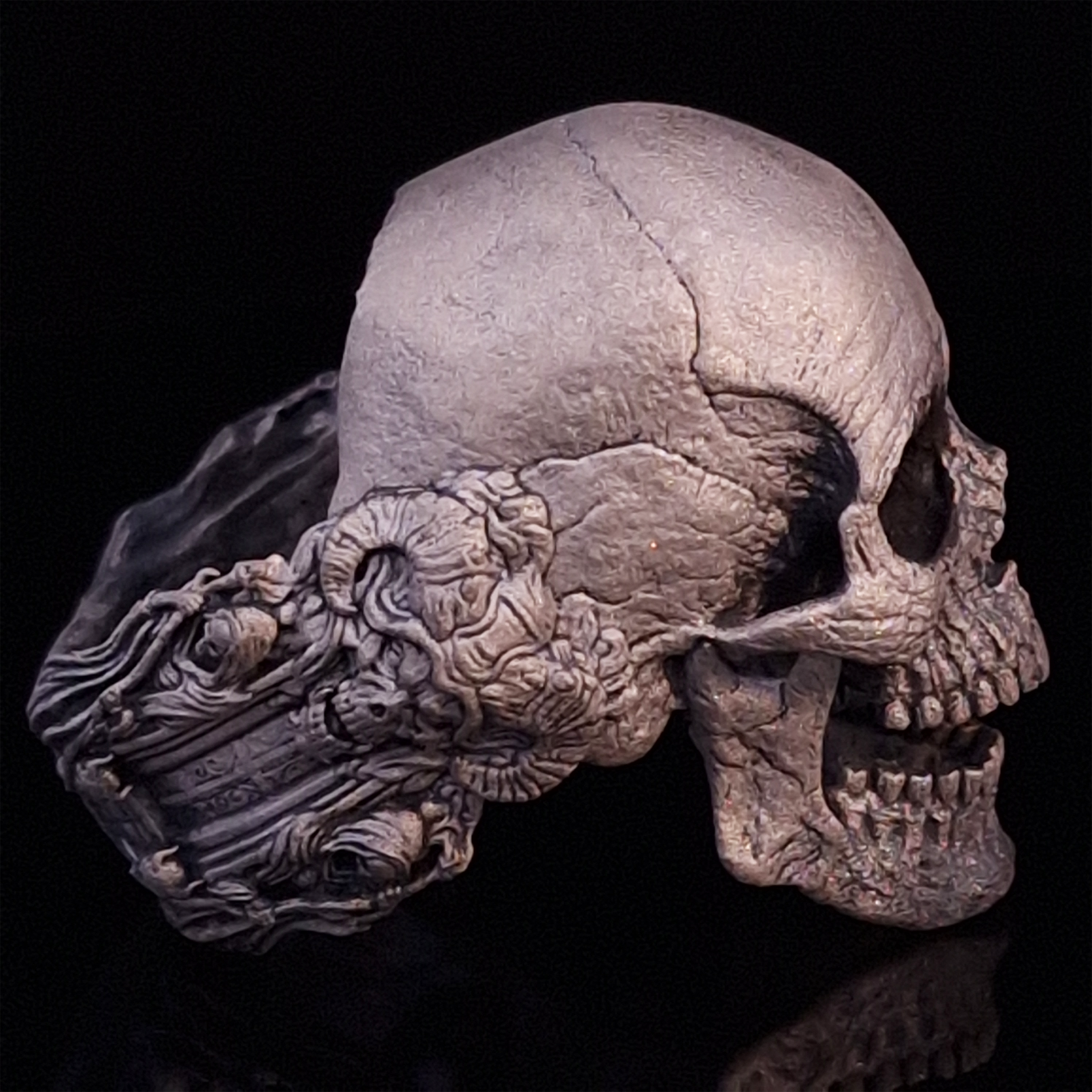 Side-right view highlighting the detailed band of the Nexus Mortis ring in the Wraith finish, shown on a turntable with a black background.