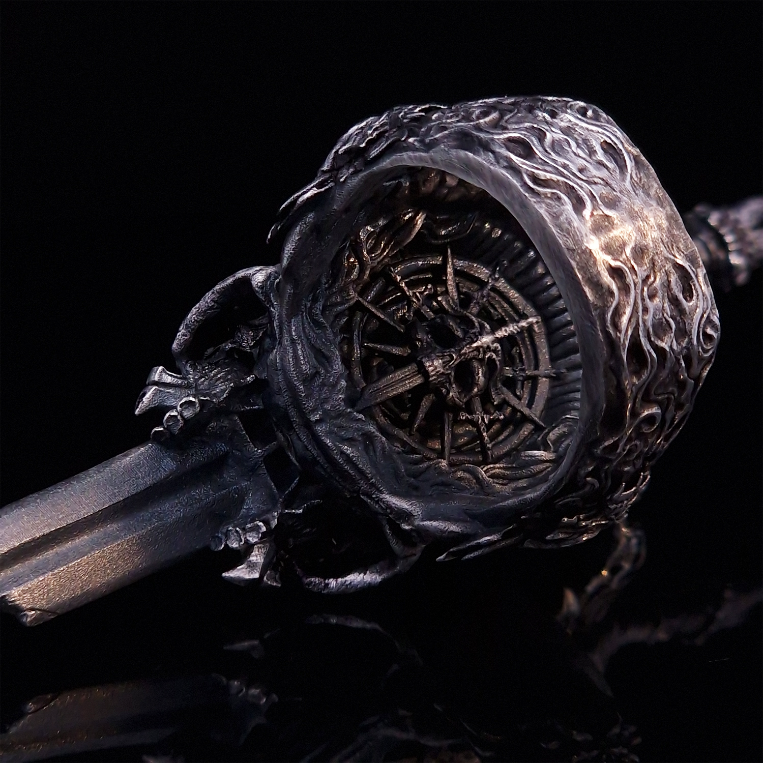 Rear view of the Adversarius Mortis ring in the Fallen finish, focusing on the internal and back design, on a turntable with a black background.