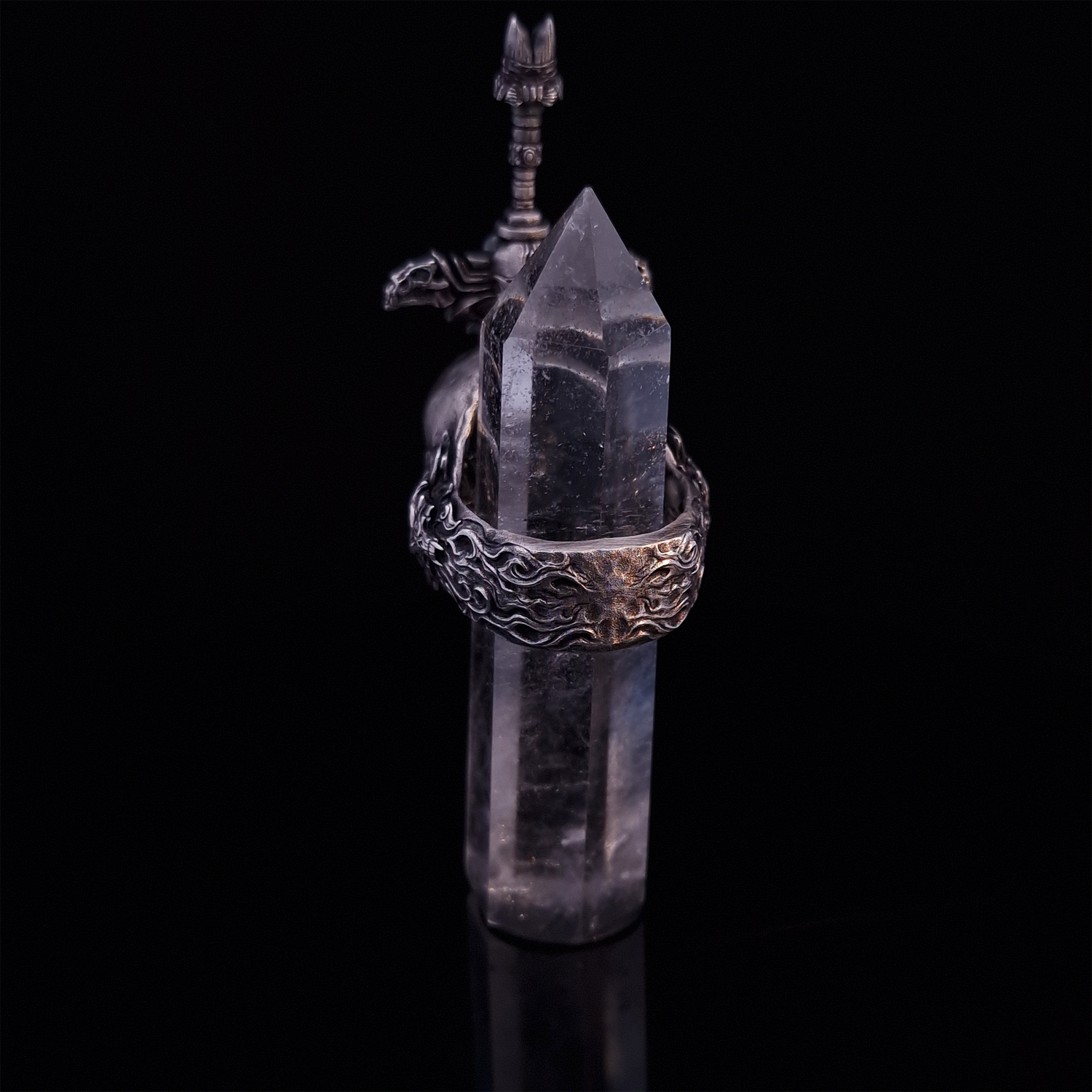 Rear view of the Adversarius Mortis ring in the Fallen finish, with crystal support visible, focusing on the intricate band design.