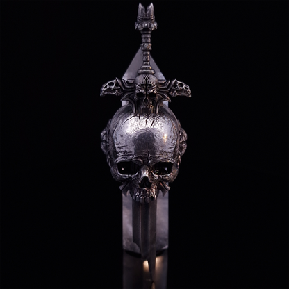 Front-facing view of the Adversarius Mortis ring in the Fallen finish, supported by a crystal for balance, shown on a turntable with a black background.