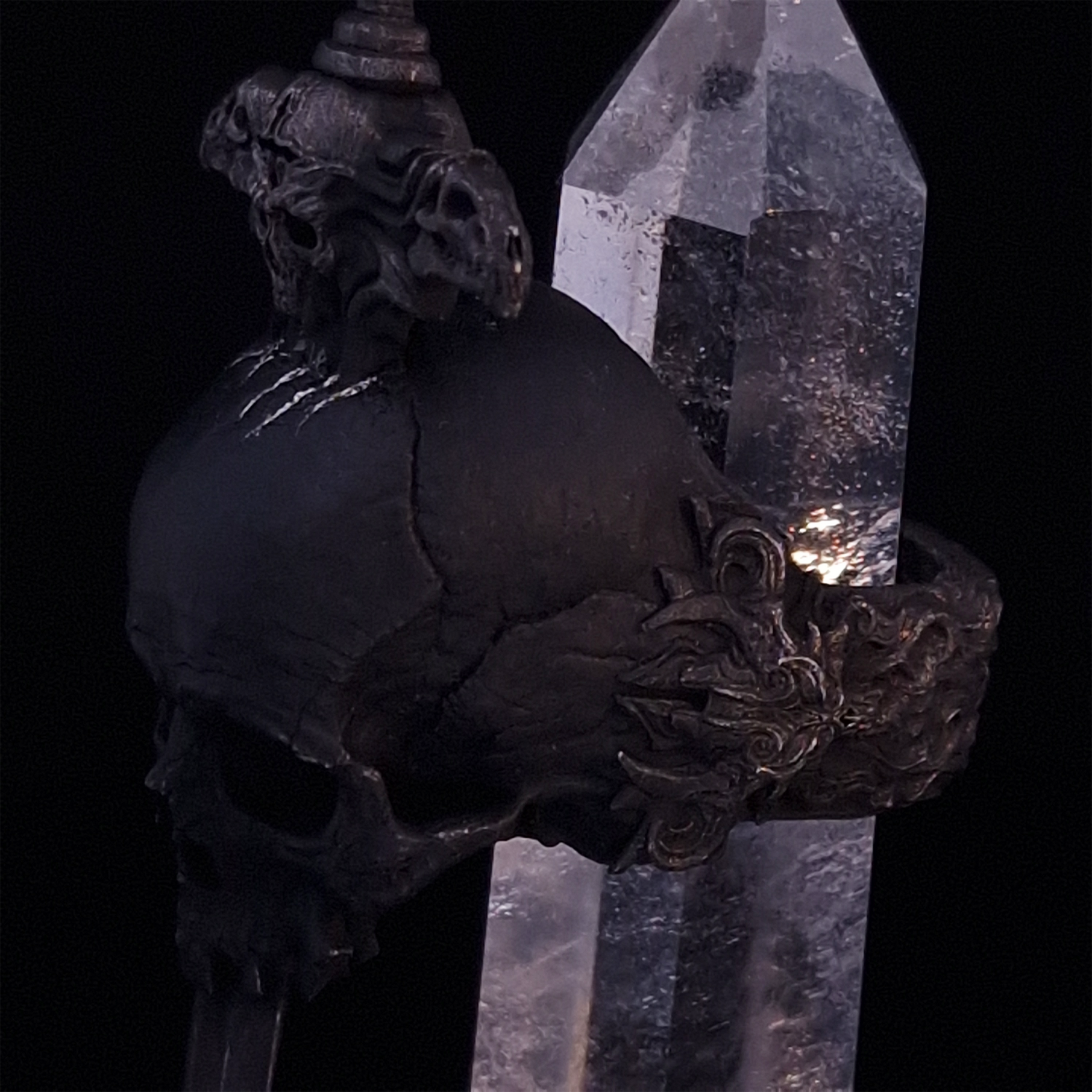 Close-up side-left view of the Adversarius Mortis ring in the Revenant 2 finish, with crystal support visible, highlighting the intricate band design on a turntable.