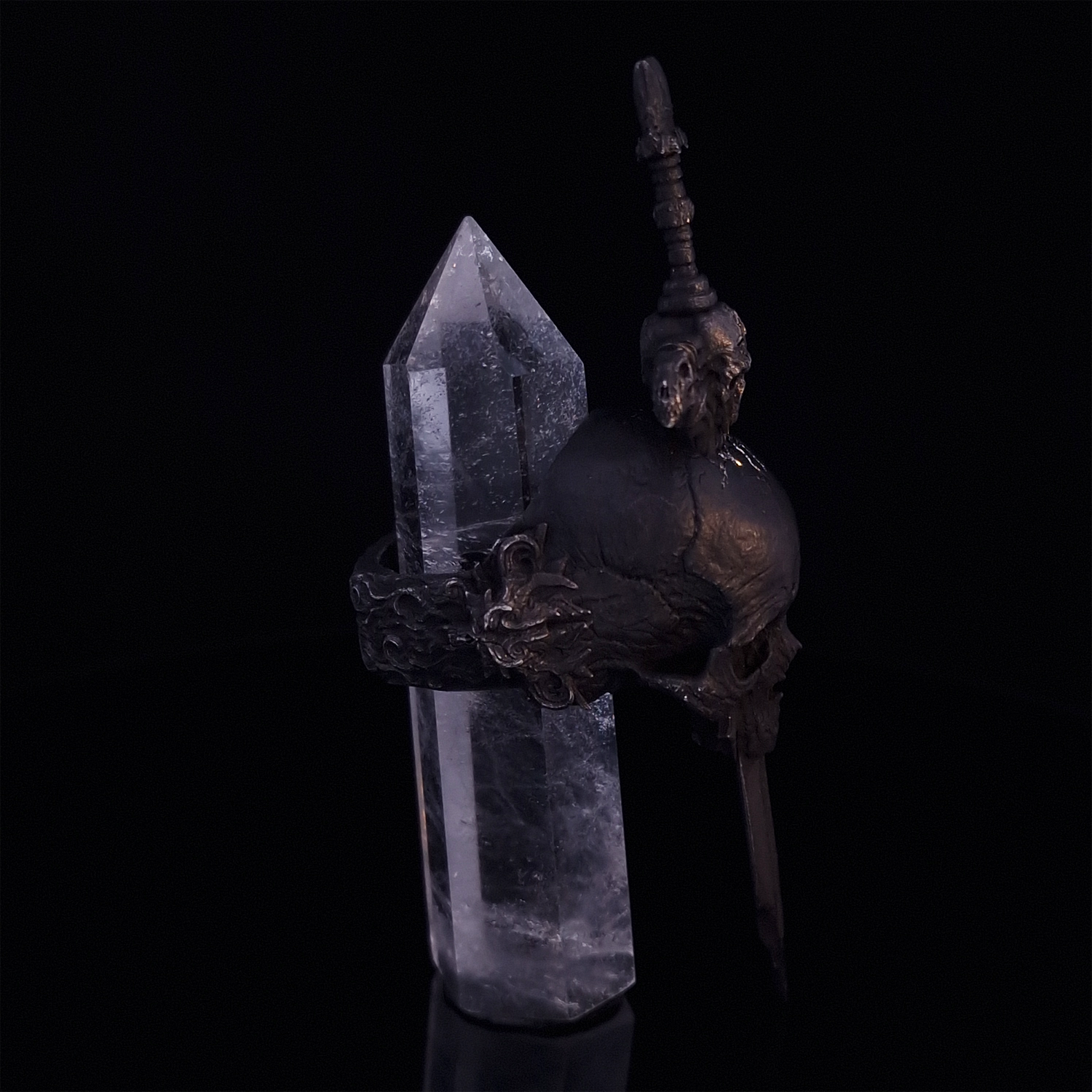 Side-right view of the Adversarius Mortis ring in the Revenant 2 finish, with crystal support visible, highlighting the intricate band design on a turntable.