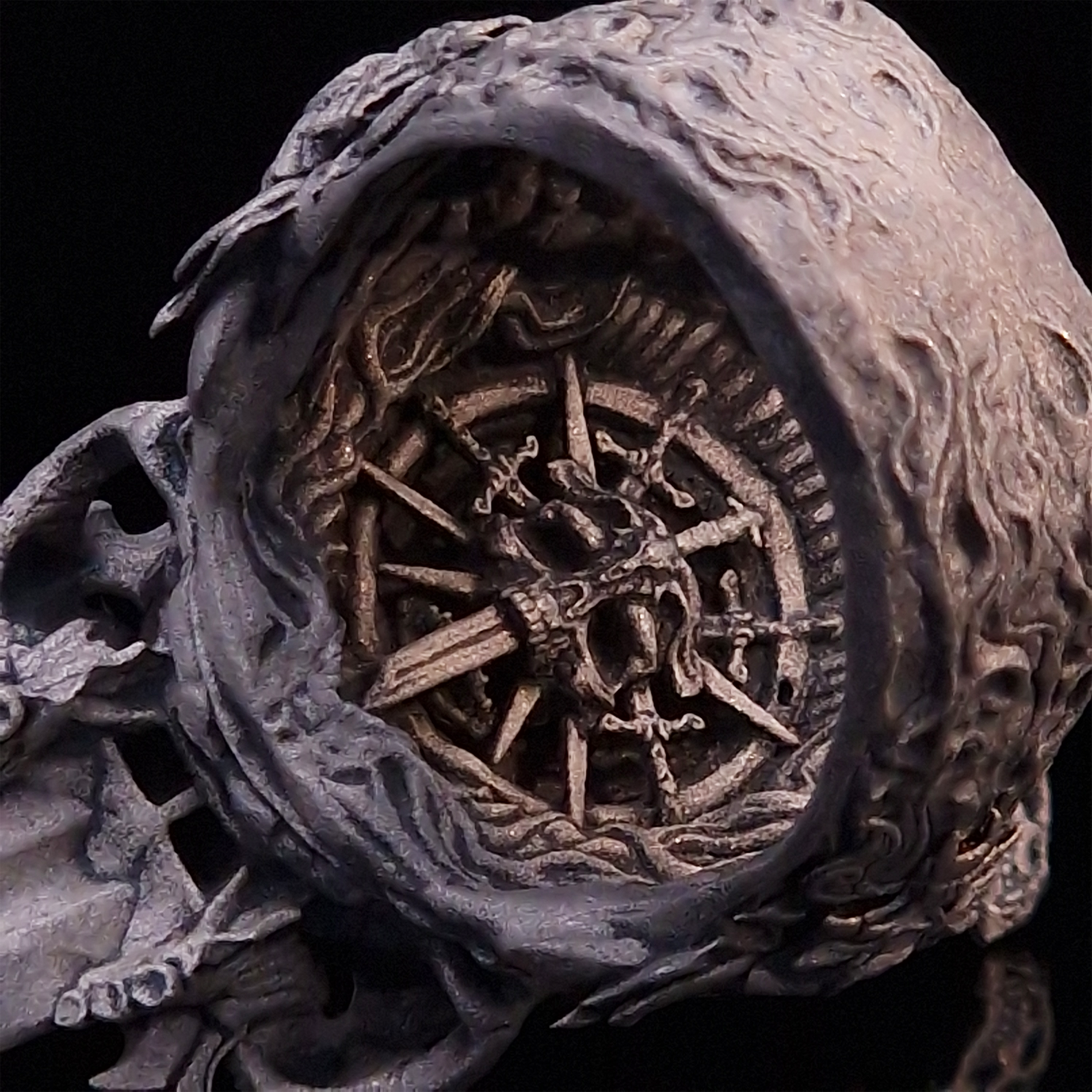 Close-up of the inner design of the Adversarius Mortis ring in the Wraith finish, against a black backdrop.
