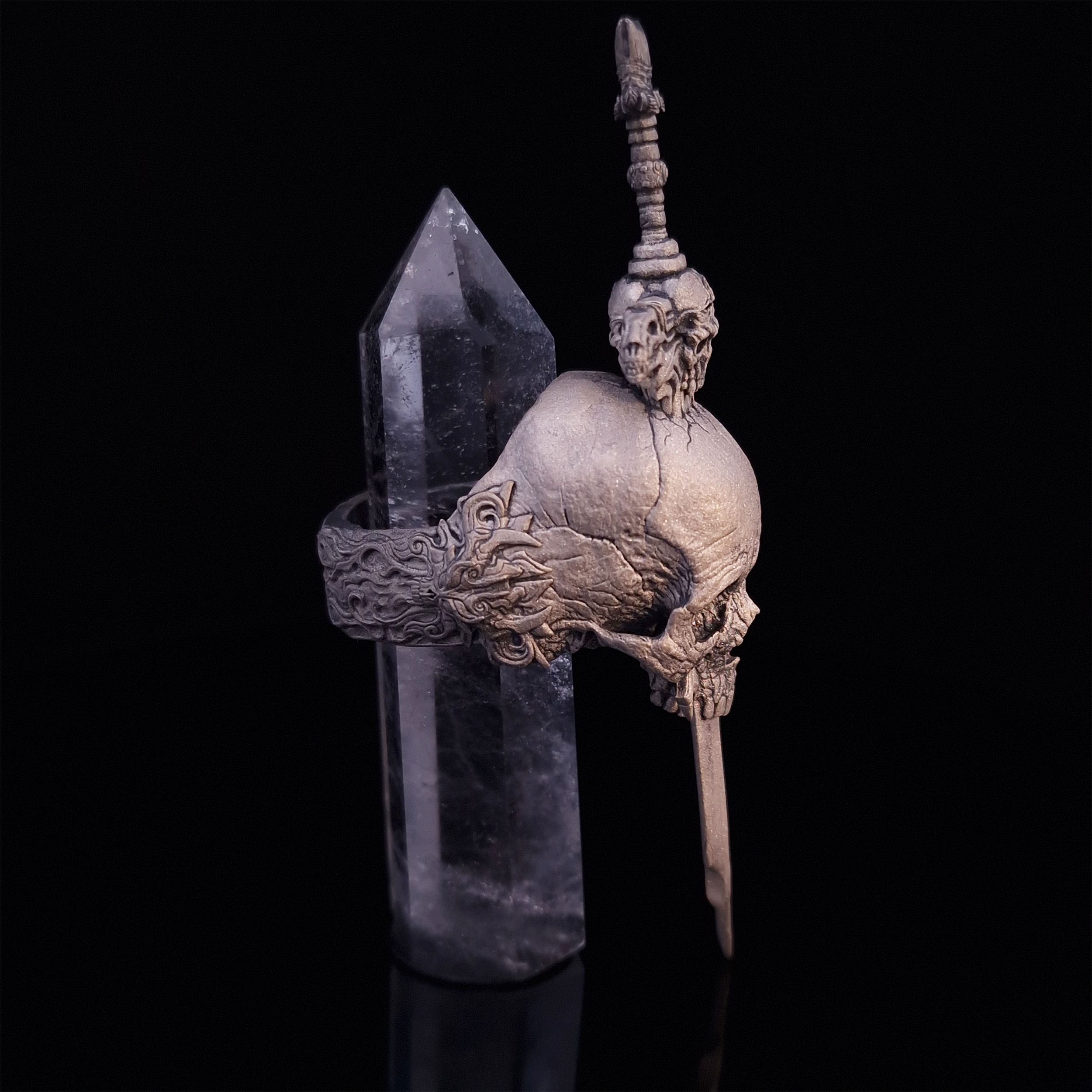 Side-right view of the Adversarius Mortis ring in the Wraith finish, with crystal support visible, highlighting the intricate band design on a turntable.