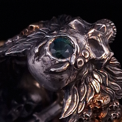 Close-up back view of the Sword of Damocles ring in the Eternal finish, focusing on the gemstone detail, on a turntable with a black background.