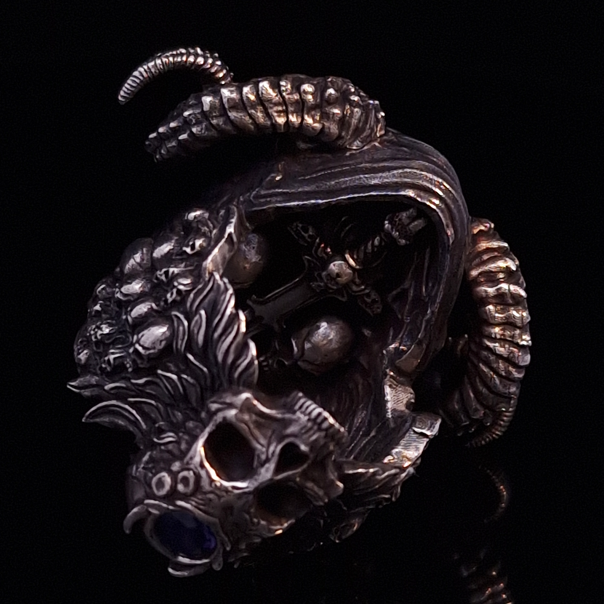 Rear close-up of the inner design of the Sword of Damocles ring in the Fallen finish, captured on a turntable with a black backdrop.