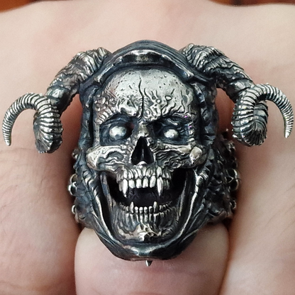 Fist pointed toward the camera in natural light, wearing the Sword of Damocles ring in the Fallen finish.