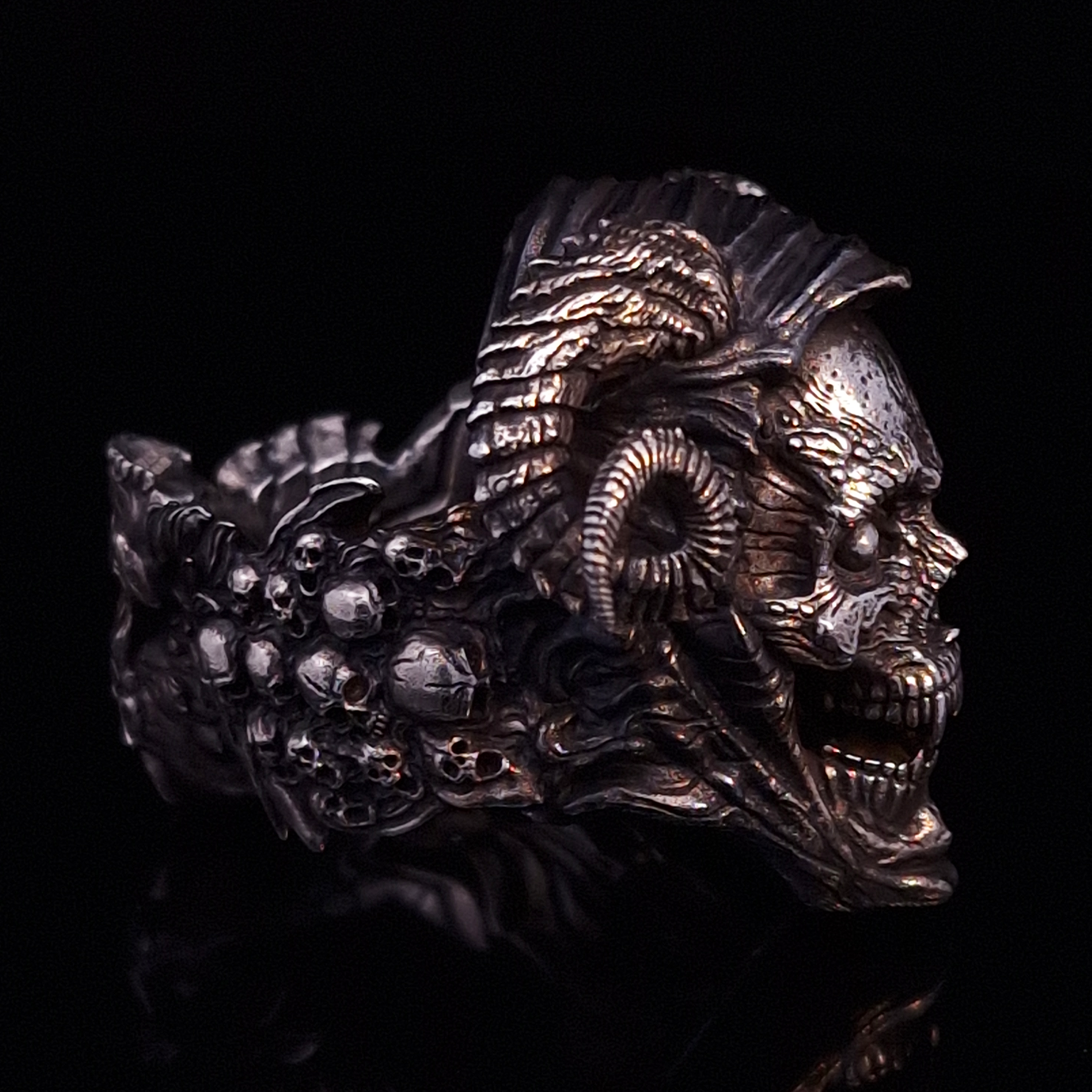 Right-facing side view highlighting the detailed band of the Sword of Damocles ring in the Fallen finish, shown on a turntable with a black background.