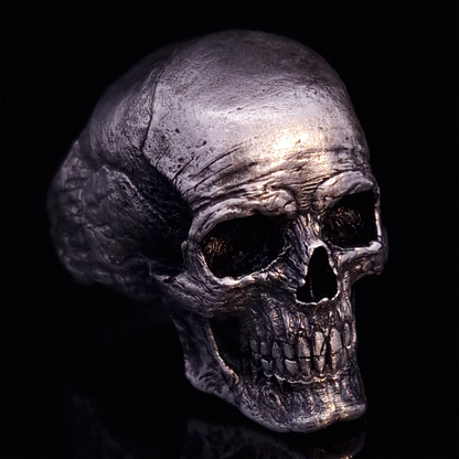 Front right view of the Invidia Mortis ring in the Fallen finish, displayed on a turntable against a black background.