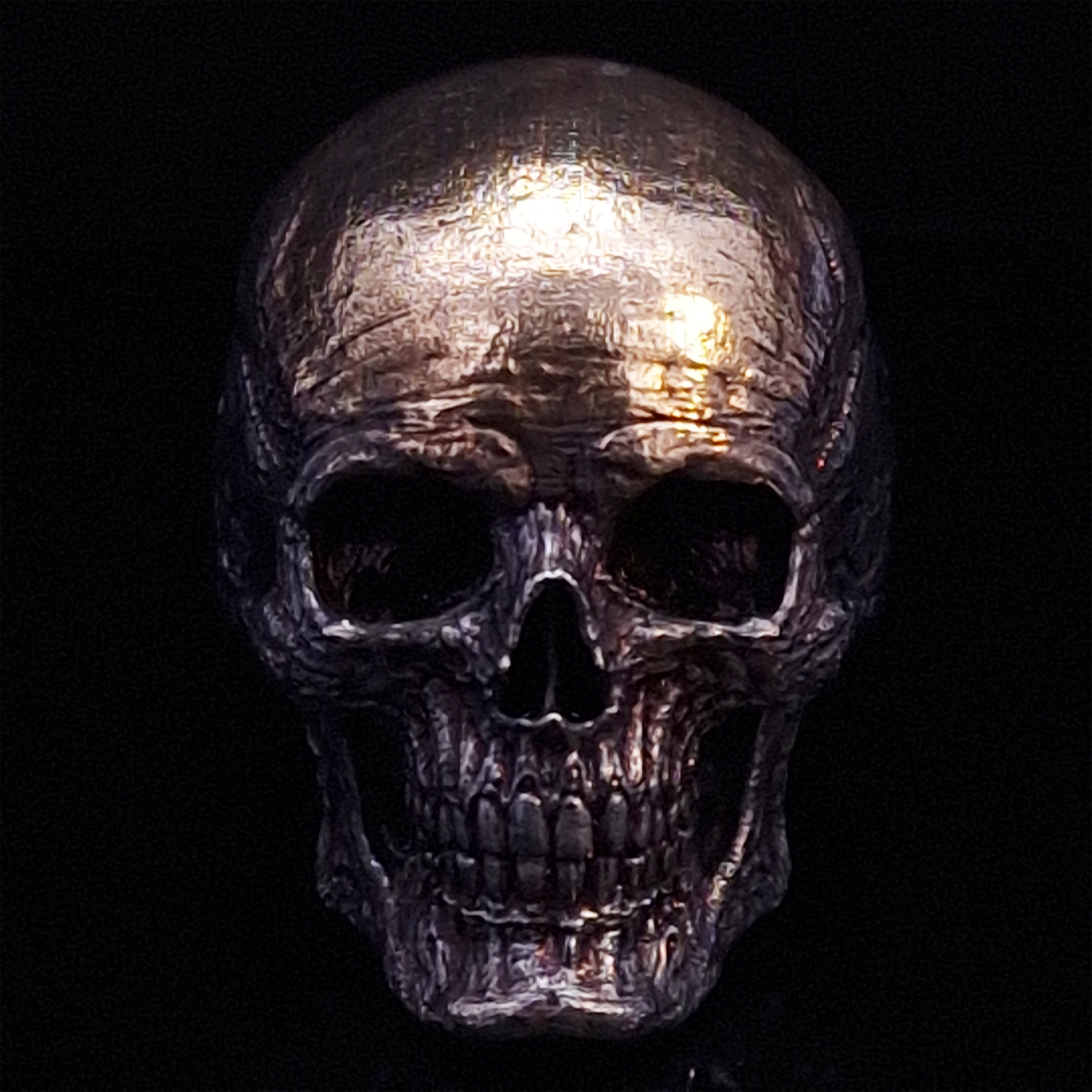 Front-facing view of the Invidia Mortis ring in the Revenant 1 finish, displayed on a turntable against a black background.
