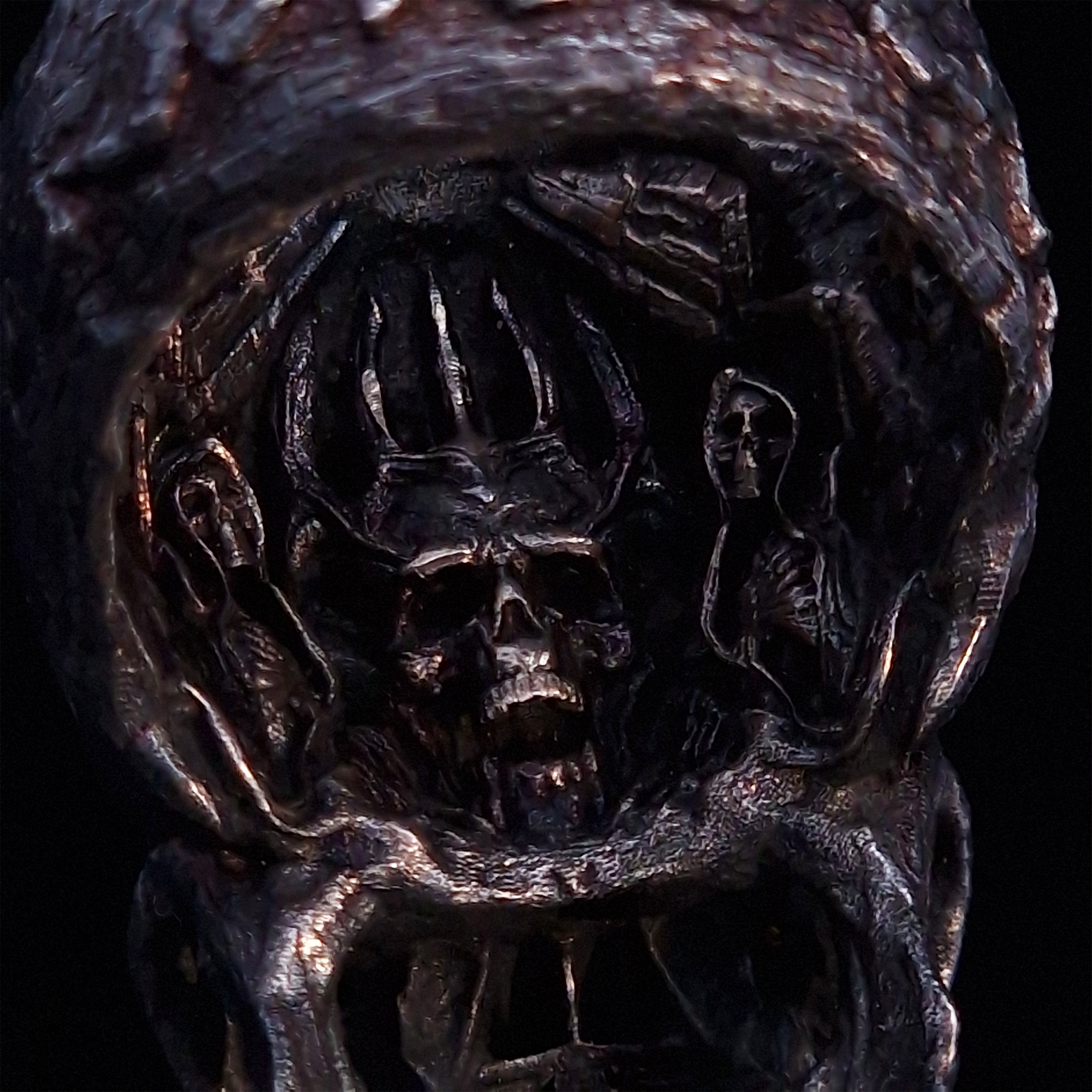 Close-up of the inner design of the Invidia Mortis ring in the Revenant 1 finish, captured on a turntable with a black backdrop.