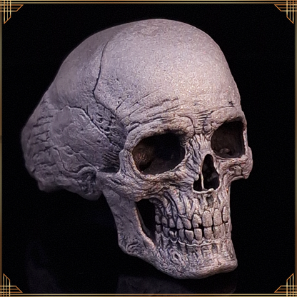 Close-up of the Invidia Mortis ring in the Wraith finish, shown facing slightly to the right, against a black background with a gold border.