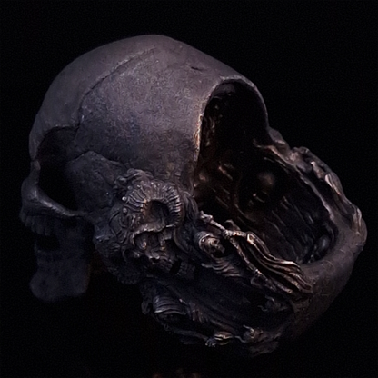 Back-left view of the Nexus Mortis ring in the Revenant 3 finish, focusing on the reaper band, on a turntable with a black background.