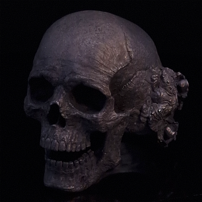 Front-left facing view of the Nexus Mortis ring in the Revenant 3 finish, displayed on a turntable against a black background.