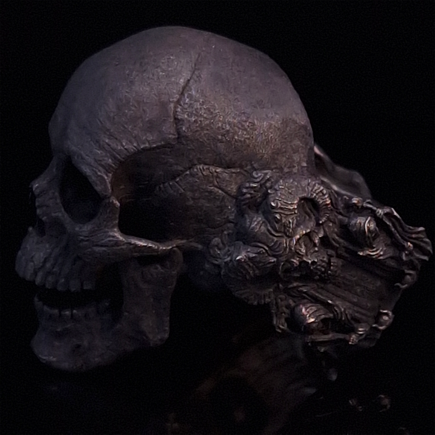 Side-left view highlighting the detailed band of the Nexus Mortis ring in the Revenant 3 finish, shown on a turntable with a black background.