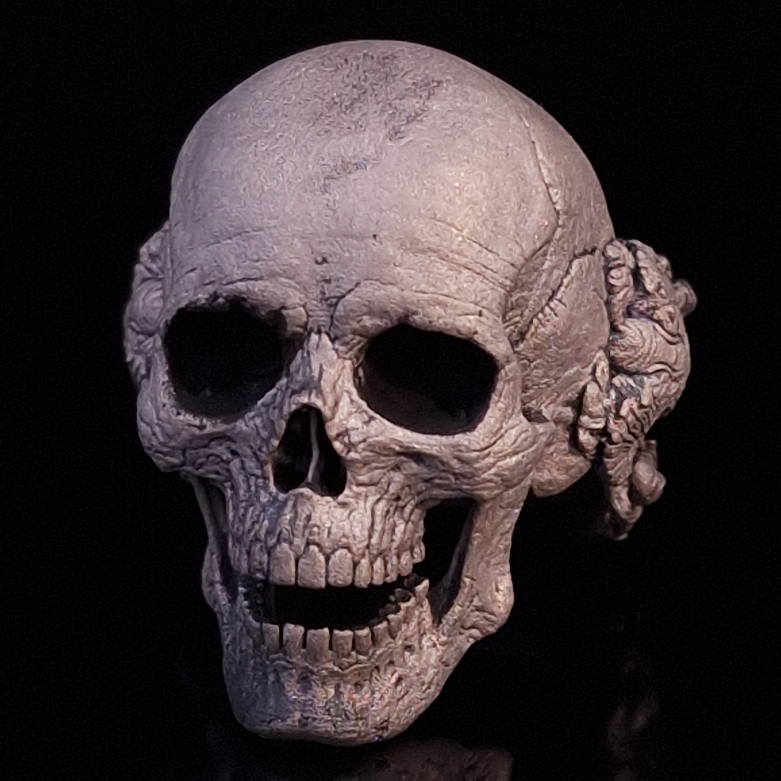 Front-left facing view of the Nexus Mortis ring in the Wraith finish, displayed on a turntable against a black background.