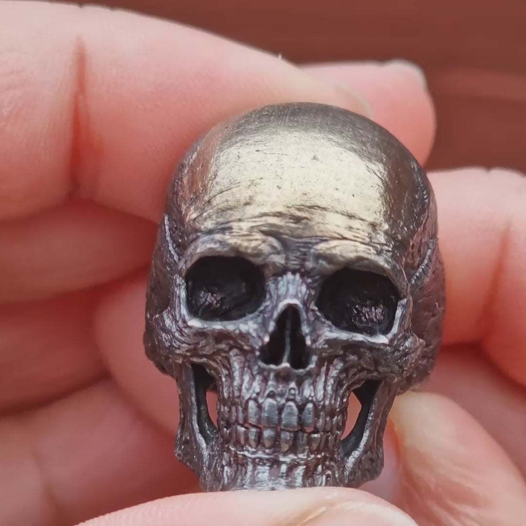 Video of the Invidia Mortis in the Revenant 1 finish being held and rotated by hand outdoors, showcasing every angle in natural light.